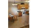 Well-lit eat-in kitchen area with warm wood cabinets and appliances at 24 Malauka Ter, Ocklawaha, FL 32179