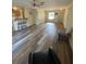 Inviting open-concept living room with bar stool seating and modern wood-look flooring at 24 Malauka Ter, Ocklawaha, FL 32179