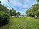 Sprawling backyard, framed by mature trees, provides a serene and private outdoor space perfect for recreation and relaxation at 2409 Nw 7Th St, Ocala, FL 34475