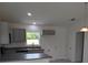 Well-lit kitchen features modern gray cabinets, granite countertops, and stainless steel appliances at 2825 Sw 147Th Ct, Ocala, FL 34481