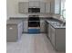 Modern kitchen with gray cabinets, stainless steel appliances, and sleek countertops at 2825 Sw 147Th Ct, Ocala, FL 34481