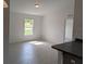 Bright living room with light tile floors, large window, and neutral paint at 2825 Sw 147Th Ct, Ocala, FL 34481