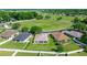 An aerial view showcasing single-story homes with manicured lawns in a tranquil community setting at 4225 Sw 57Th Ave, Ocala, FL 34474