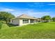 A well-maintained backyard featuring a lawn and the exterior of a single Gathering home at 4225 Sw 57Th Ave, Ocala, FL 34474