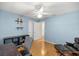 Light-blue bedroom featuring a ceiling fan, wood-look floors, and a closet at 4225 Sw 57Th Ave, Ocala, FL 34474