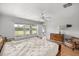 Bright bedroom with natural light, featuring a ceiling fan and wood floors, offering a serene and comfortable space at 4225 Sw 57Th Ave, Ocala, FL 34474