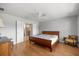 Spacious main bedroom with wood floors, ceiling fan, and an ensuite bathroom with a large walk-in closet at 4225 Sw 57Th Ave, Ocala, FL 34474