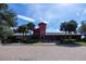Charming clubhouse with a red brick facade, palm trees, landscaping, and convenient bike racks at 4225 Sw 57Th Ave, Ocala, FL 34474