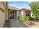 Inviting front entrance with decorative landscaping and a storm door at 4225 Sw 57Th Ave, Ocala, FL 34474