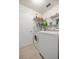 Bright laundry room featuring a white washer, dryer, and metal shelving at 4225 Sw 57Th Ave, Ocala, FL 34474