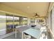 Spacious screened patio with outdoor seating and ceiling fan overlooking the backyard at 4225 Sw 57Th Ave, Ocala, FL 34474