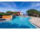 Resort-style pool with vibrant clubhouse and mature landscaping under a sunny sky at 4225 Sw 57Th Ave, Ocala, FL 34474
