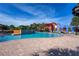 Resort-style pool area with comfortable lounge chairs and colorful umbrellas for relaxation at 4225 Sw 57Th Ave, Ocala, FL 34474