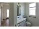 Clean bathroom with white vanity, sink, and a modern black-framed mirror at 4345 Nw 27Th Pl, Ocala, FL 34482