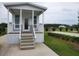 Charming cottage-style home with a cozy porch and well-maintained landscaping in a serene community setting at 4345 Nw 27Th Pl, Ocala, FL 34482