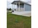 Quaint cottage featuring a cozy porch, complemented by lush green grass and outdoor seating area at 4345 Nw 27Th Pl, Ocala, FL 34482