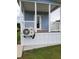 Charming cottage home featuring a covered porch, complemented by green lawn and pleasant outdoor setting at 4345 Nw 27Th Pl, Ocala, FL 34482