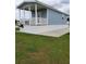 Exterior view of a cottage with covered porch, showcasing manicured lawn and charming community at 4345 Nw 27Th Pl, Ocala, FL 34482