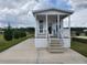Charming single-story tiny home with a covered porch and manicured lawn at 4345 Nw 27Th Pl, Ocala, FL 34482