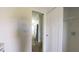 Hallway with a closet showcasing shelving and access to kitchen appliances at 4345 Nw 27Th Pl, Ocala, FL 34482