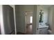 Hallway leads to a bathroom featuring a white vanity at 4345 Nw 27Th Pl, Ocala, FL 34482