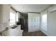 Well-lit kitchen features white cabinetry, stainless steel appliances, and light wood flooring at 4345 Nw 27Th Pl, Ocala, FL 34482