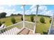 View from the porch with white railing overlooking the grassy front yard at 4345 Nw 27Th Pl, Ocala, FL 34482