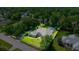 Expansive aerial view showcasing a lush, landscaped property with a screened-in pool and well-maintained grounds at 4812 Se 12Th Pl, Ocala, FL 34471