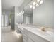 Bright bathroom featuring double vanity, a soaking tub, and glass-enclosed shower at 4812 Se 12Th Pl, Ocala, FL 34471