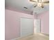 A spacious bedroom featuring neutral walls, a ceiling fan, and a large closet enhances comfortable living at 4812 Se 12Th Pl, Ocala, FL 34471