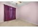 A bright bedroom with plush carpeting and a modern ceiling fan offers a comfortable living space at 4812 Se 12Th Pl, Ocala, FL 34471