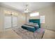 Bedroom featuring plush blue bed, ceiling fan, and natural light from windows and sliding glass doors at 4812 Se 12Th Pl, Ocala, FL 34471