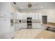 Well-lit kitchen with white cabinetry, granite countertops, stainless steel appliances, and tile flooring at 4812 Se 12Th Pl, Ocala, FL 34471