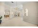 Open living room with neutral walls, architectural arches and a chandelier at 4812 Se 12Th Pl, Ocala, FL 34471