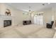 Living room with neutral carpeting and a cozy fireplace adjacent to sliding doors leading to the patio at 4812 Se 12Th Pl, Ocala, FL 34471