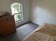 Bedroom featuring carpet, a dresser and window with outside view at 4911 Se 135Th Pl, Summerfield, FL 34491
