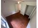Bright bedroom with hardwood floors, closet and ceiling fan at 4911 Se 135Th Pl, Summerfield, FL 34491