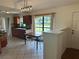 Kitchen featuring dark wood cabinets, a window with view and eat-in dining area at 4911 Se 135Th Pl, Summerfield, FL 34491
