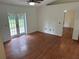 Bright living room with hardwood floors, french doors to the exterior, and easy access to other rooms at 4911 Se 135Th Pl, Summerfield, FL 34491