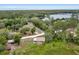 Stunning aerial view of property with a lake surrounded by lush greenery and mature trees at 531 Ne 142Nd Ave, Silver Springs, FL 34488