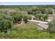 Aerial view of the home in a serene, wooded neighborhood with plenty of trees and greenery at 531 Ne 142Nd Ave, Silver Springs, FL 34488