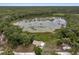 Beautiful aerial view showcasing the house, pond, and the surrounding lush greenery at 531 Ne 142Nd Ave, Silver Springs, FL 34488