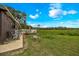 Expansive backyard featuring a patio area with outdoor seating, lush green grass, and a wooded backdrop at 531 Ne 142Nd Ave, Silver Springs, FL 34488