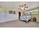 Relaxing bedroom with ceiling fan, en-suite bathroom, and natural lighting at 531 Ne 142Nd Ave, Silver Springs, FL 34488