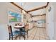 Cozy kitchen area features a dining table and a view of the serene outdoors through a large window at 531 Ne 142Nd Ave, Silver Springs, FL 34488