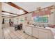 Charming kitchen with wood beam ceiling, vintage accents, tiled floor, and bright windows at 531 Ne 142Nd Ave, Silver Springs, FL 34488