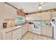 Well-lit kitchen with ample counter space, a microwave, and plenty of storage in the white cabinets at 531 Ne 142Nd Ave, Silver Springs, FL 34488