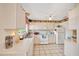 Functional kitchen with white cabinetry, tiled backsplash, and ample countertop space for meal preparation at 531 Ne 142Nd Ave, Silver Springs, FL 34488