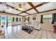 Bright living room showcasing beamed ceiling, comfortable seating, and views of the outdoor landscape at 531 Ne 142Nd Ave, Silver Springs, FL 34488