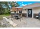 Relax on this inviting patio with a table, chairs, and shade provided by an umbrella at 531 Ne 142Nd Ave, Silver Springs, FL 34488
